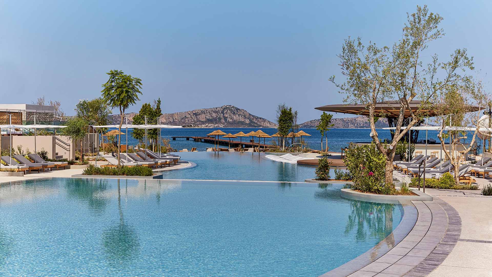 Infinity pool and beach pier at W Costa Navarino