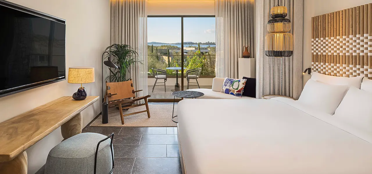 Deluxe Bay View room at W Costa Navarino with a balcony over the bay