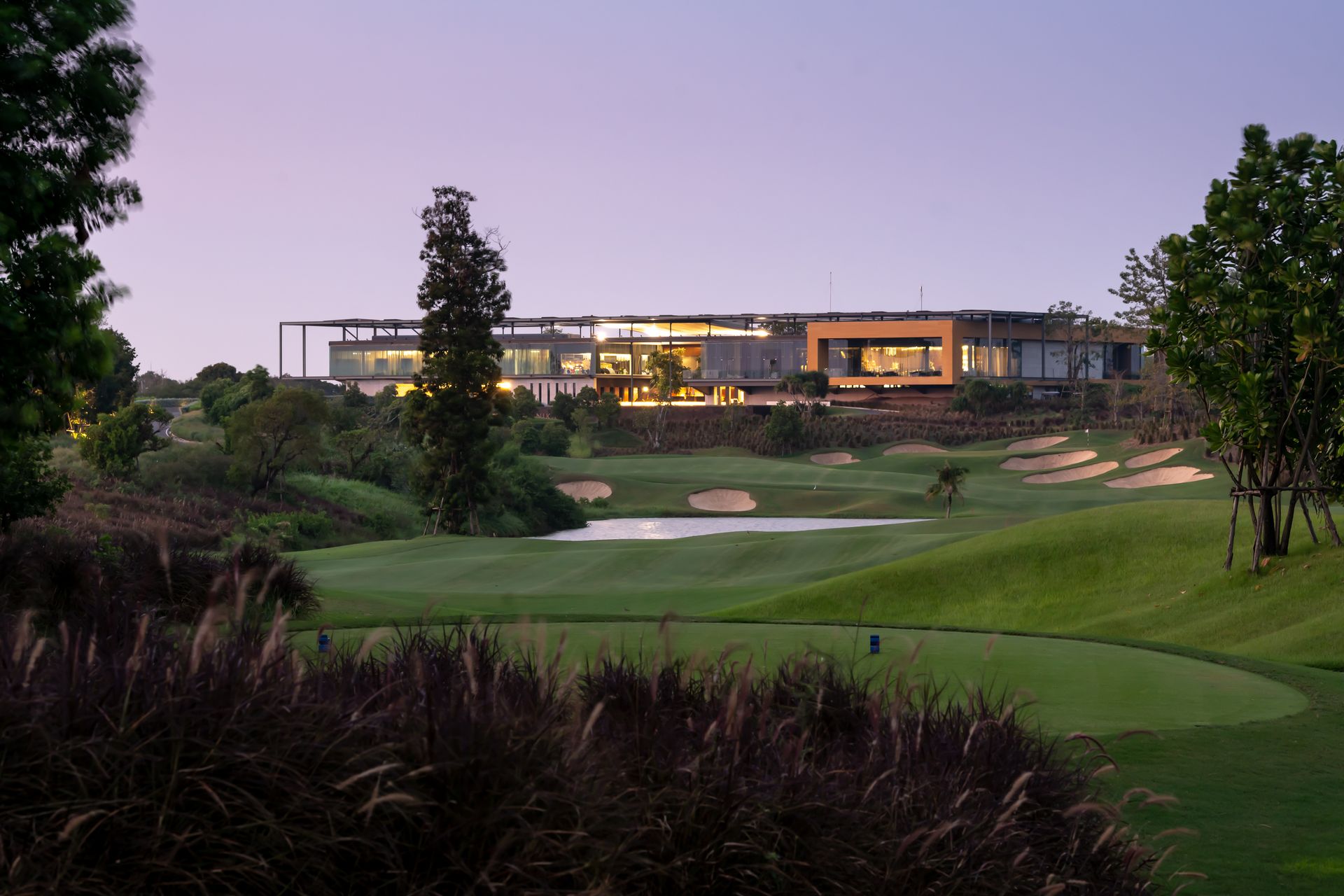 Lake and green below the clubhouse at Nikanti Golf Club at dusk